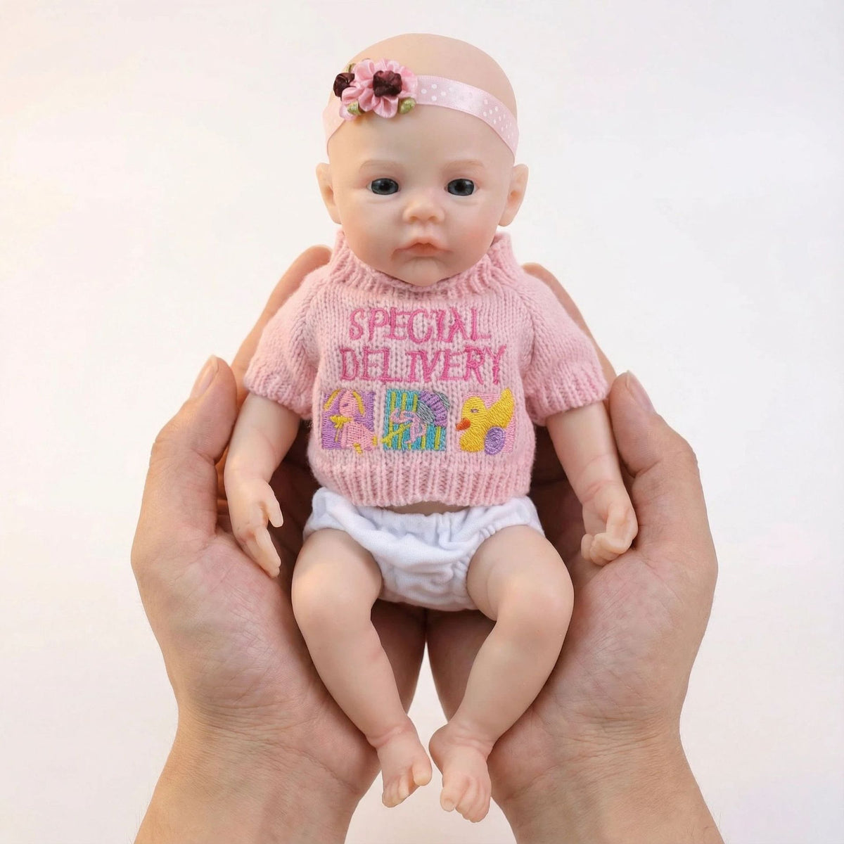 12 inch pink sweater top with meadow solid silicone reincarnation doll as a Christmas gift for children